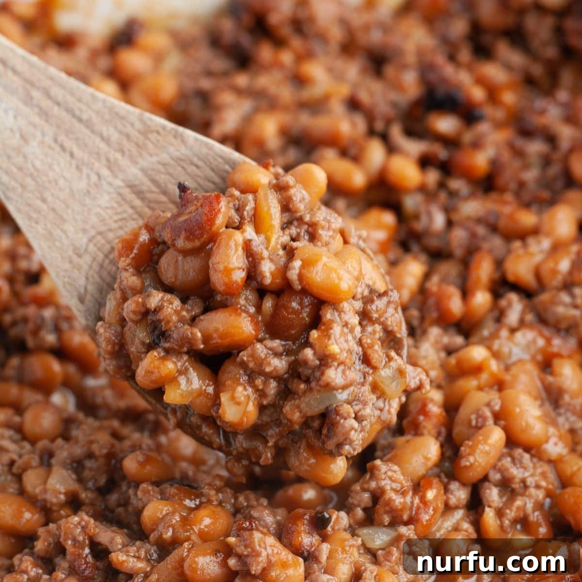 31 Perfect Side Dishes for Potato Salad 5 Wooden spoon with baked beans.