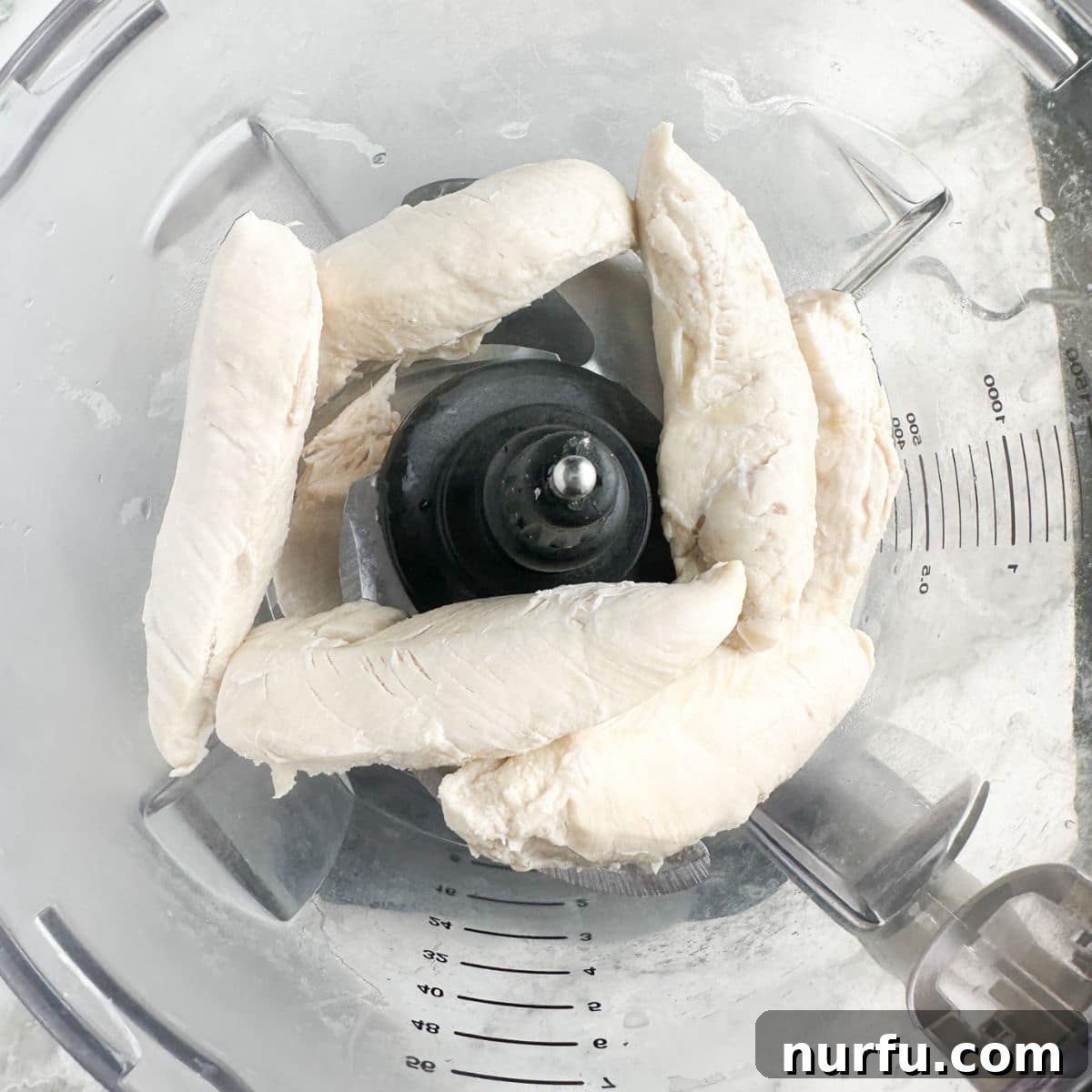 Homemade Classic Carol Chicken Salad Chick 4 Cooked chicken tenderloins being shredded in a food processor.