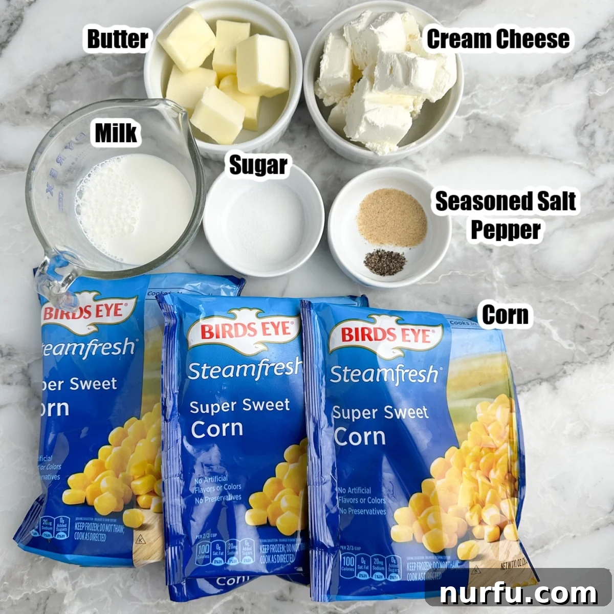 Dreamy Slow Cooker Cream Cheese Corn 3 A vibrant flat lay photo showcasing all the fresh and frozen ingredients meticulously arranged on a rustic wooden surface, ready for slow cooker cream cheese corn. Bags of frozen corn, a block of cream cheese, sticks of butter, a carton of half-and-half, sugar, and various seasonings are clearly visible.