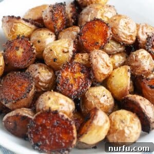 Bowl of seasoned roasted potatoes, ready to be served.