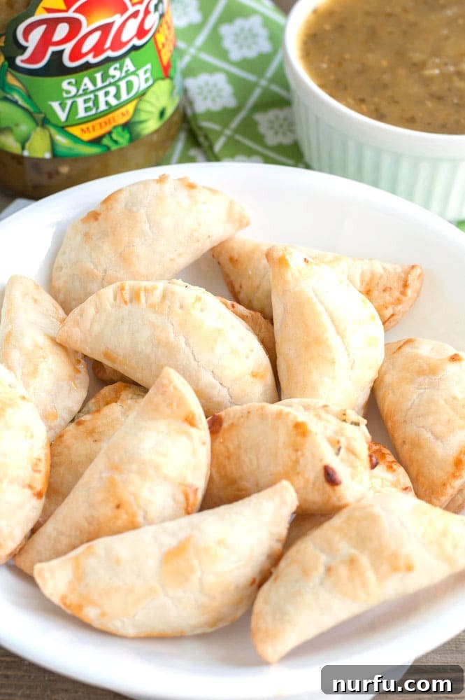 Delicious Salsa Verde Empanadas Salsa Verde Empanadas arranged on a serving platter, perfect for game day snacks.