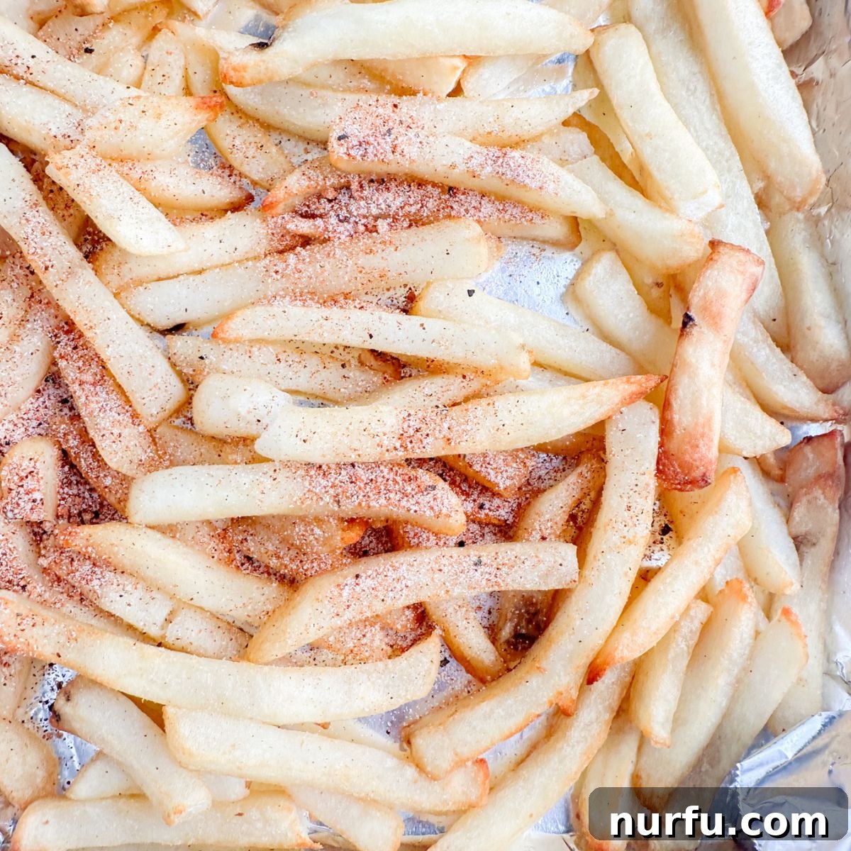 Homemade Wingstop Louisiana Voodoo Fries Magic 5 Seasoned fries on a foil lined tray.