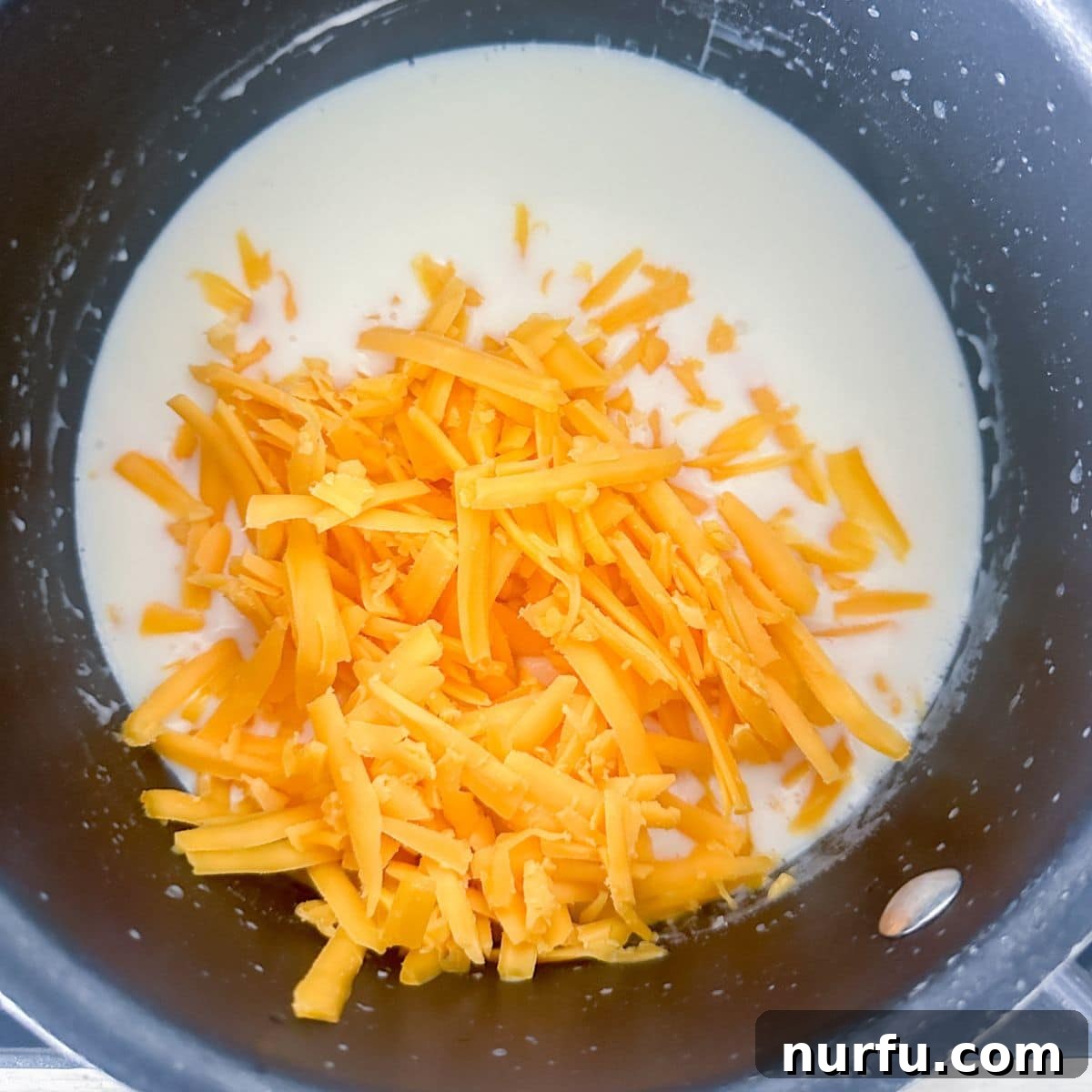 Homemade Wingstop Louisiana Voodoo Fries Magic 7 Pot with shredded cheese and milk.