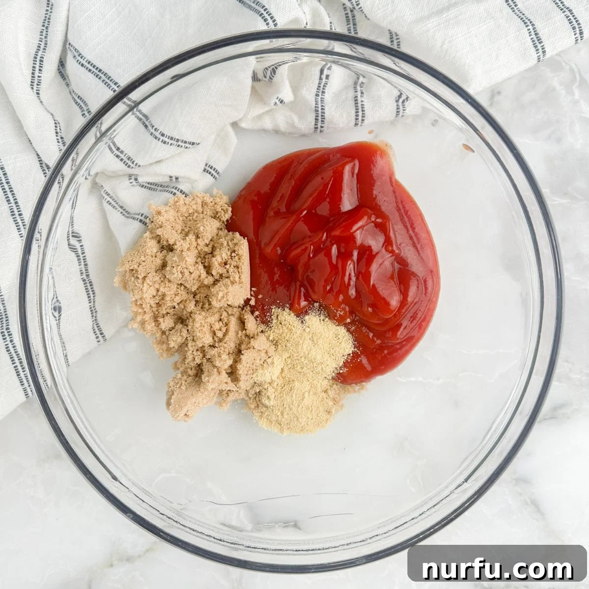 Ultimate Meatloaf Sauce 4 Empty bowl with ketchup on one side, ground mustard and brown sugar on the other, before mixing.