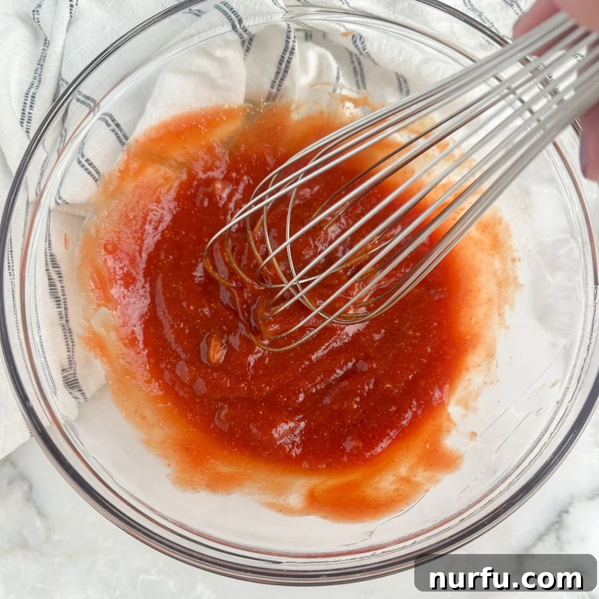 Ultimate Meatloaf Sauce 5 Bowl of meatloaf sauce with a whisk, showing a smooth, mixed consistency.