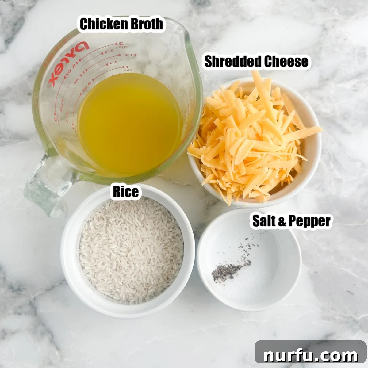 Creamy Cheesy Rice Cooker Perfection 3 The simple ingredients for cheesy rice: uncooked long grain rice, chicken broth, salt, pepper, and a bowl of shredded cheddar cheese.