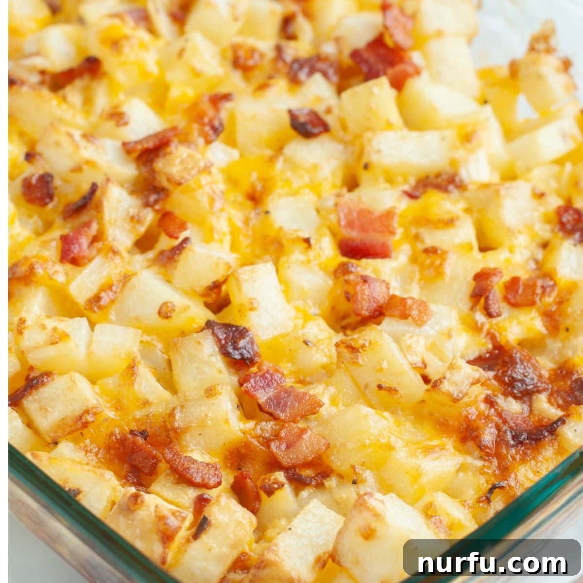 Deep South Mud Pie Potatoes 8 A casserole dish filled with baked diced potatoes, golden melted cheese, and crispy bacon, fresh from the oven.