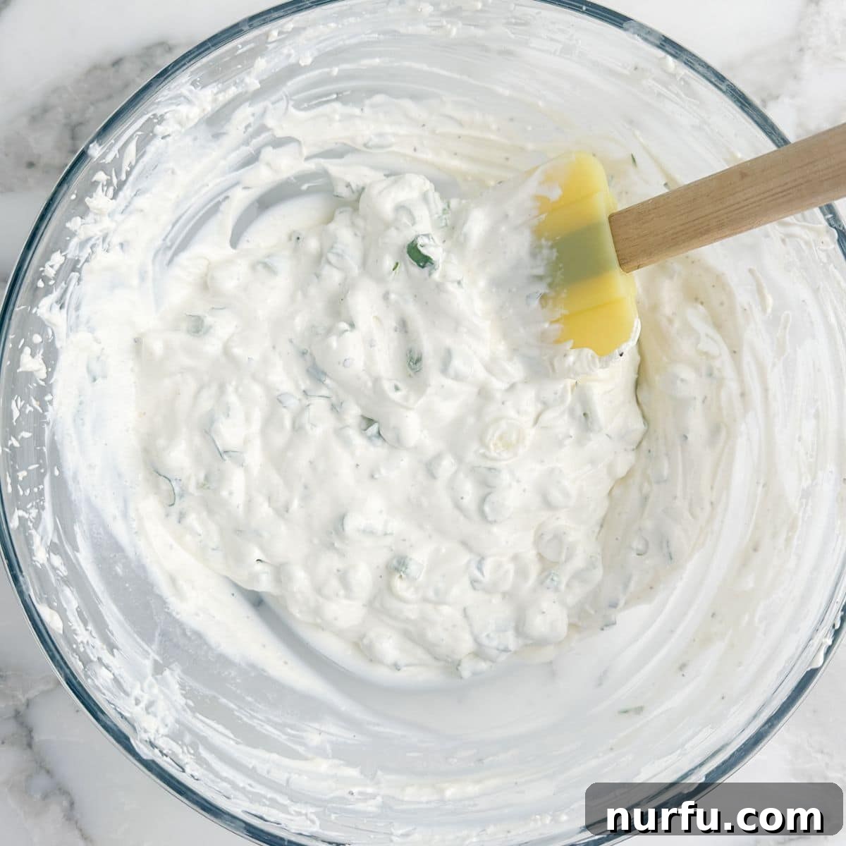 Savory Scallion Dip 6 A bowl of freshly made green onion dip, ready to be chilled and served, showcasing its inviting creamy texture and vibrant green specks of onion and parsley.