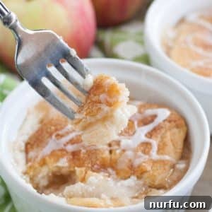 Bowl with apple crisp and apples in background.