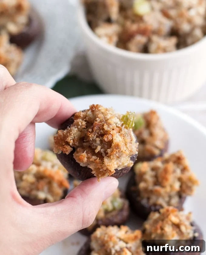A close-up of a single stuffing stuffed mushroom, perfectly golden and ready to be enjoyed as an elegant appetizer.