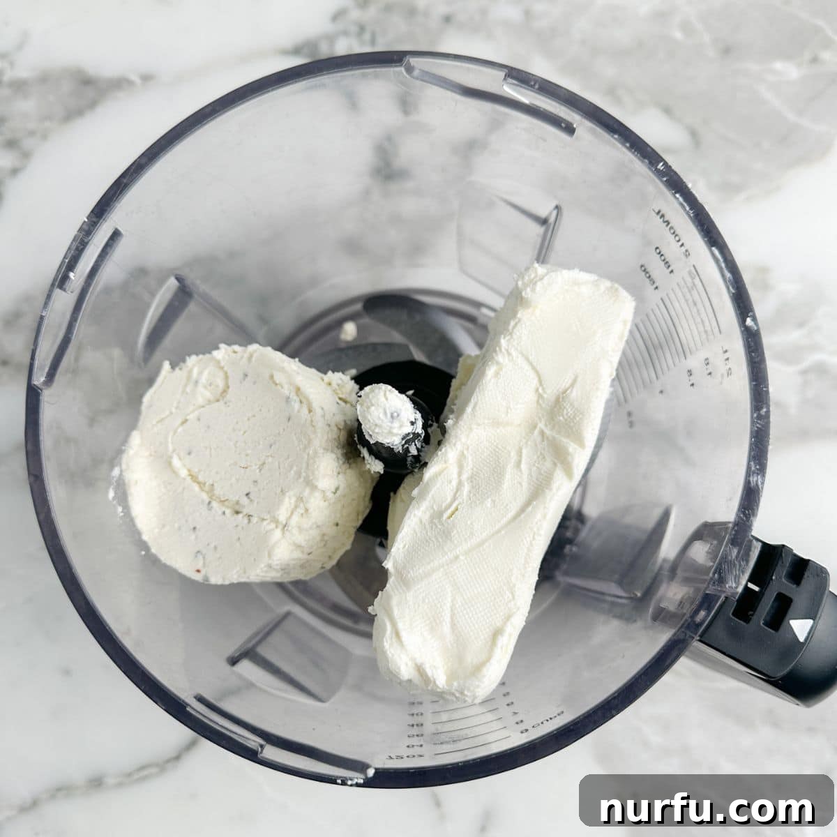 Fig & Bacon Boursin Bliss 4 Softened cream cheese and Boursin cheese placed together in a food processor bowl, ready for whipping.