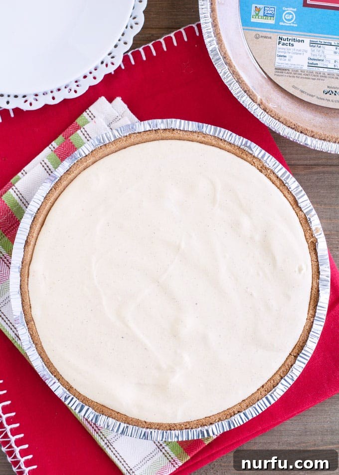 No Bake Egg nog pie Eggnog pie dessert on a festive serving dish, garnished with a dusting of nutmeg.