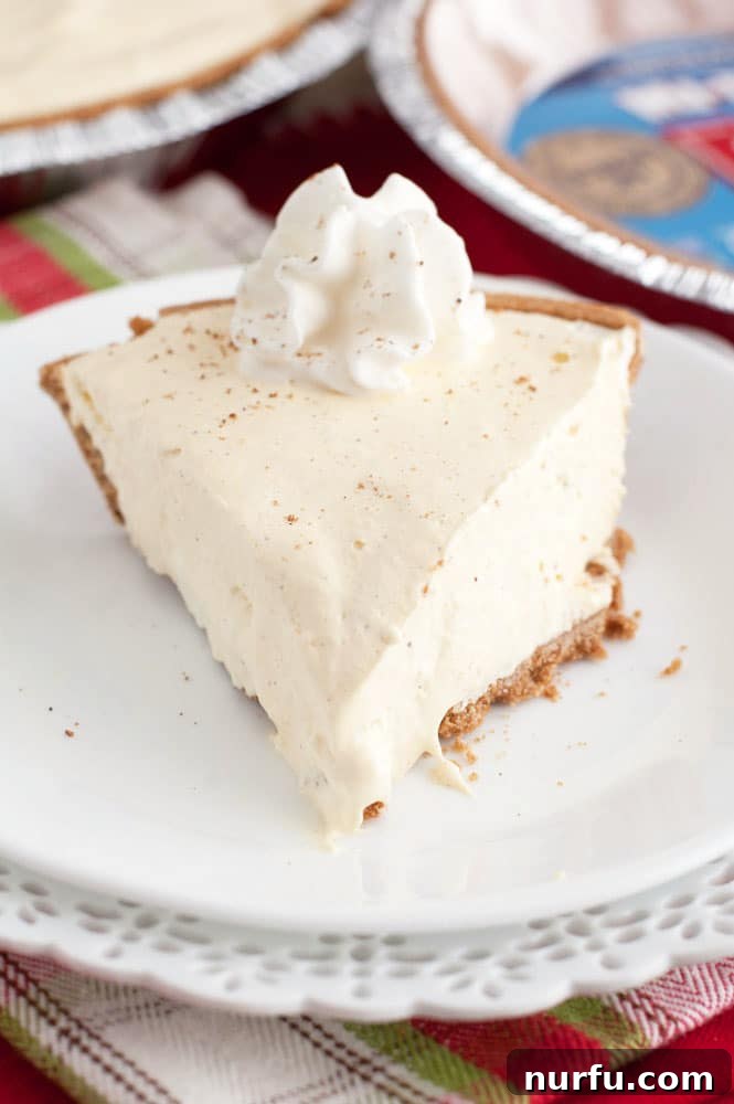 No Bake Egg nog pie Full no-bake eggnog pie, ready to be served, sitting on a wooden surface.