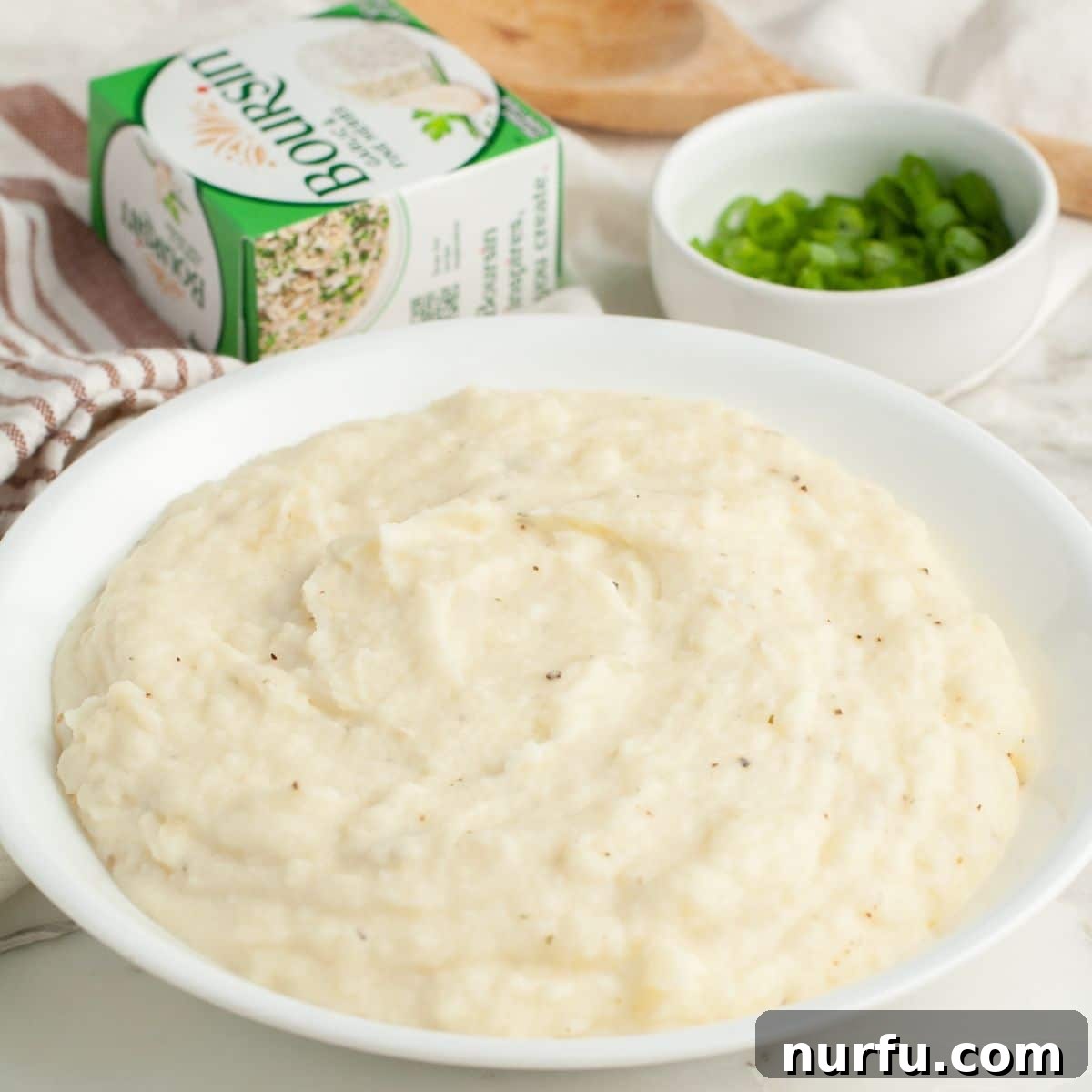 Velvety Boursin Garlic Herb Mash 7 A large serving bowl filled with creamy Boursin mashed potatoes, ready to be served.
