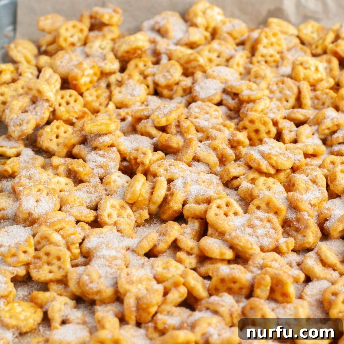 Churro Fiesta Mix 6 A close-up of the finished Honeycomb churro snack mix, sparkling with cinnamon sugar and broken into delectable pieces.