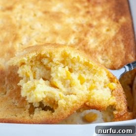 A spoonful of creamy corn pudding, golden and inviting.