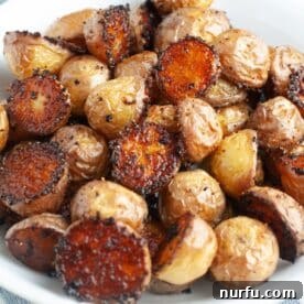 A bowl of perfectly seasoned oven roasted small potatoes, golden and inviting.