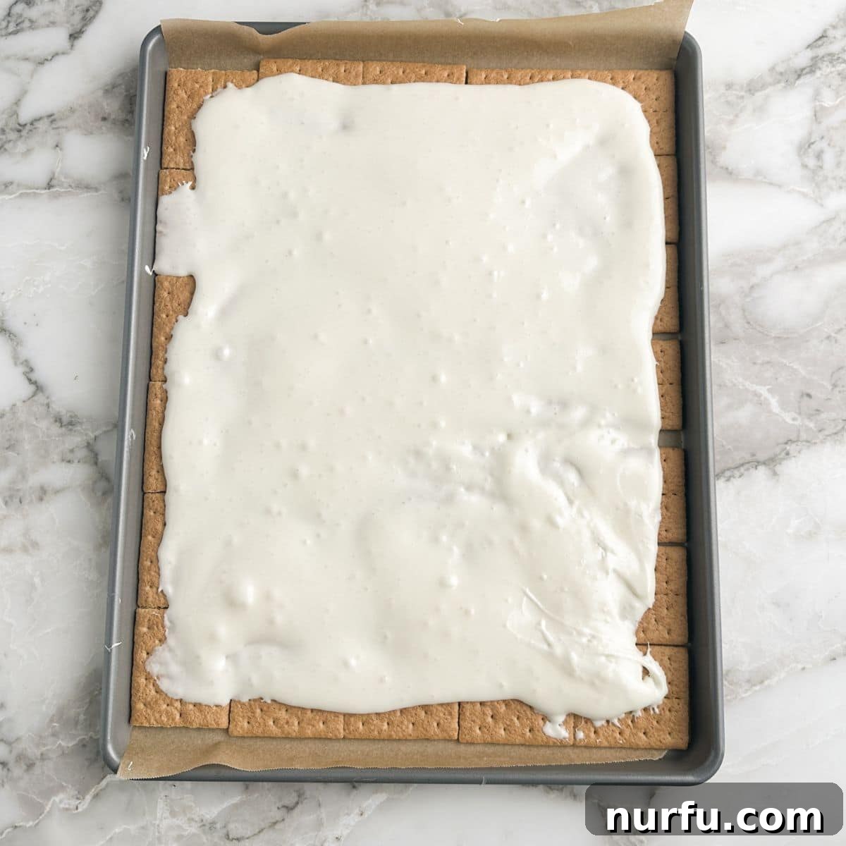 Irresistible S'mores Bark 5 Graham crackers covered with a layer of melted marshmallows.