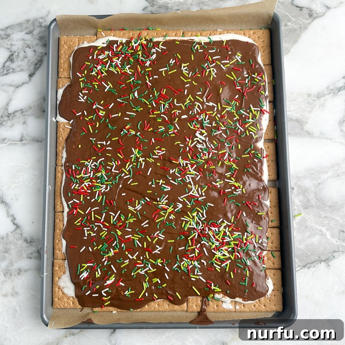 Irresistible S'mores Bark 7 Pieces of S'mores bark topped with colorful sprinkles, ready to be served.