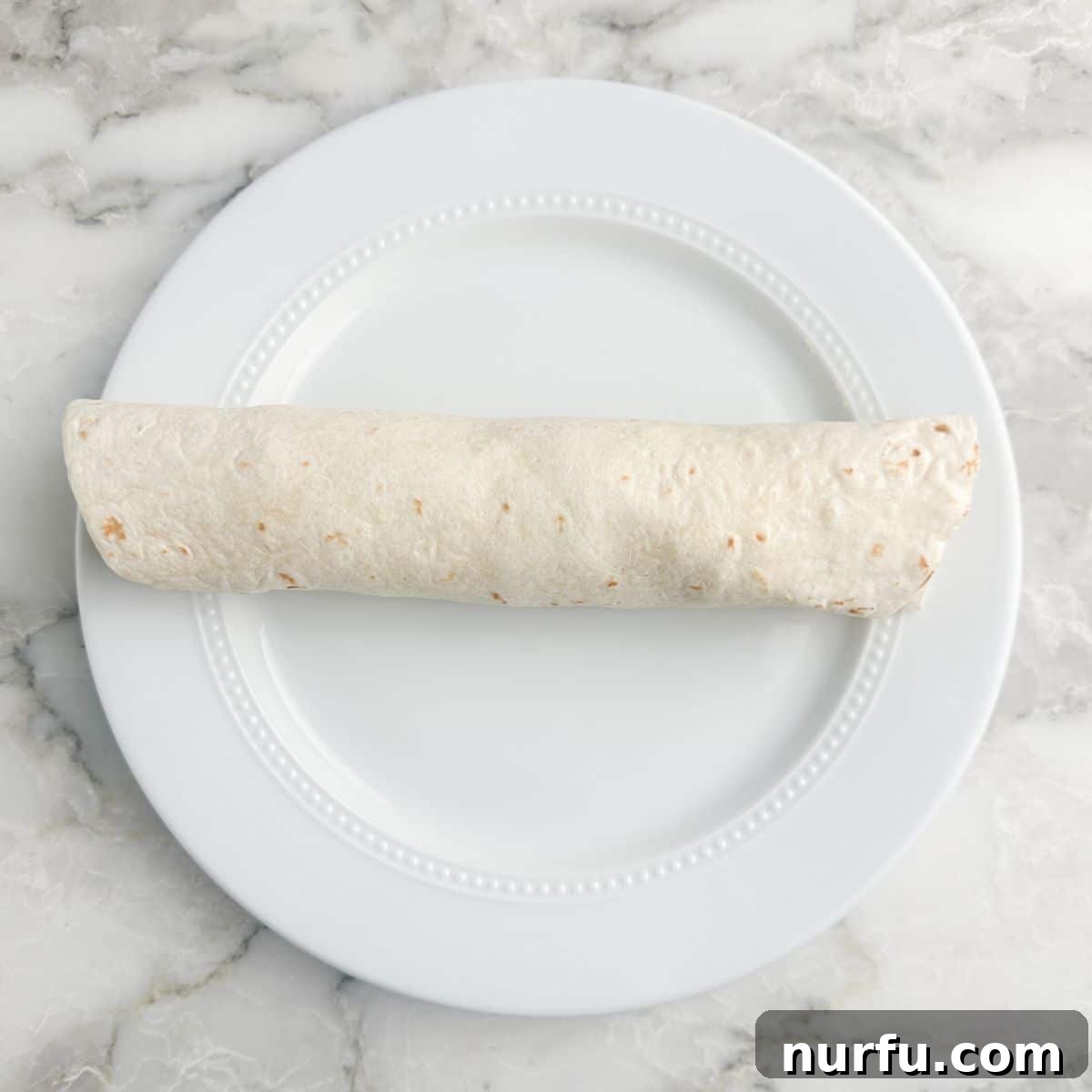 Italian Spiral Bites 8 A freshly rolled tortilla, tightly wrapped and ready for chilling.