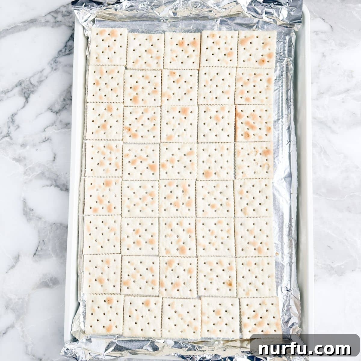 Cinnamon Caramel Saltines 4 Baking pan with Saltine crackers arranged in a single layer.