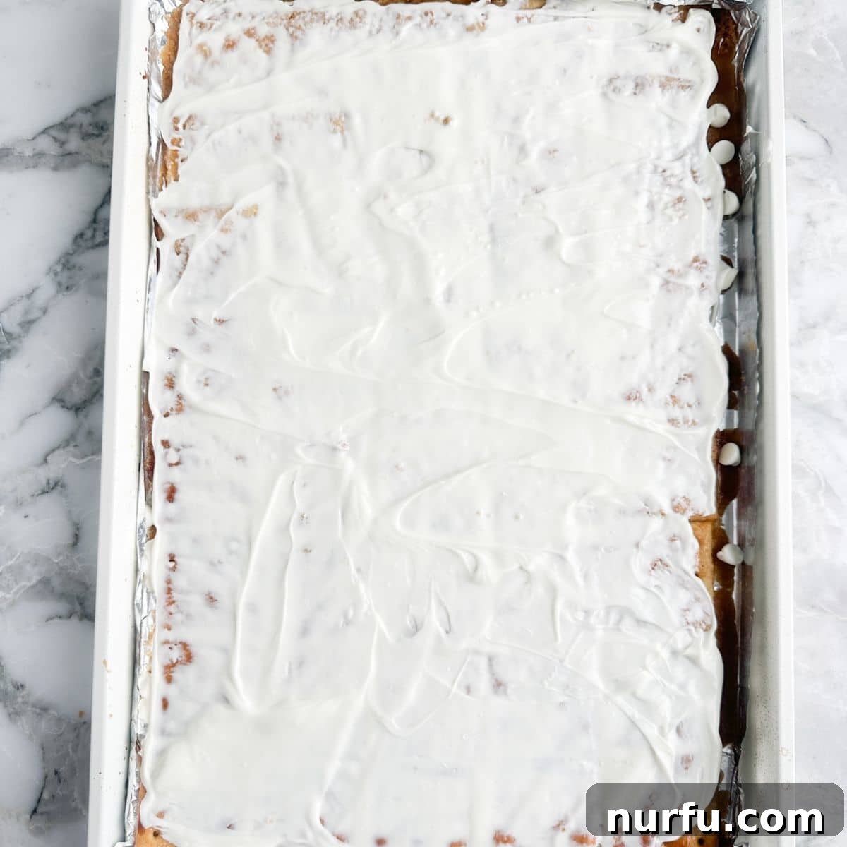 Cinnamon Caramel Saltines 8 Crackers covered in toffee and melted white chocolate, ready for cinnamon sugar.