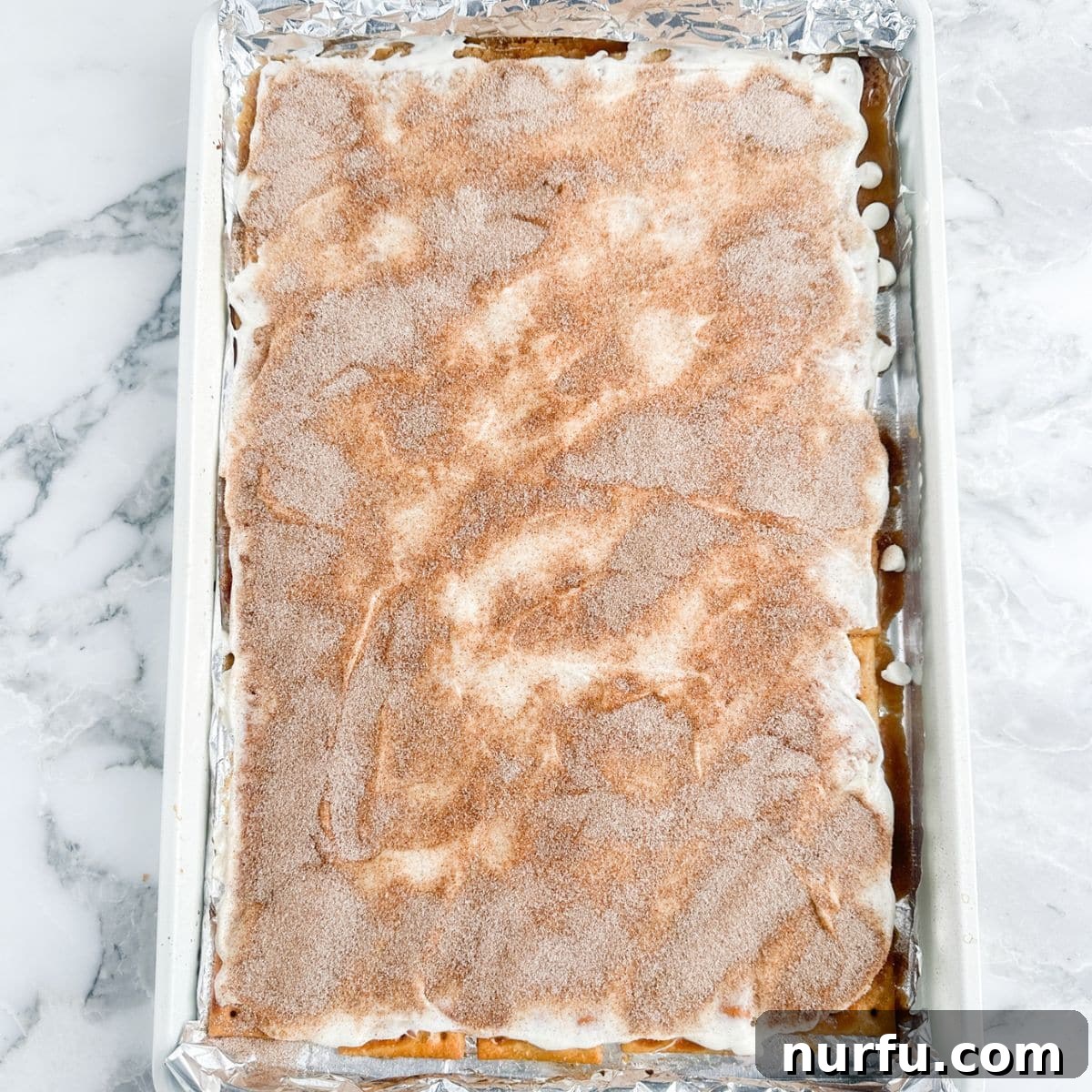 Cinnamon Caramel Saltines 9 Finished churro toffee cooling on a baking sheet, sprinkled with cinnamon sugar.