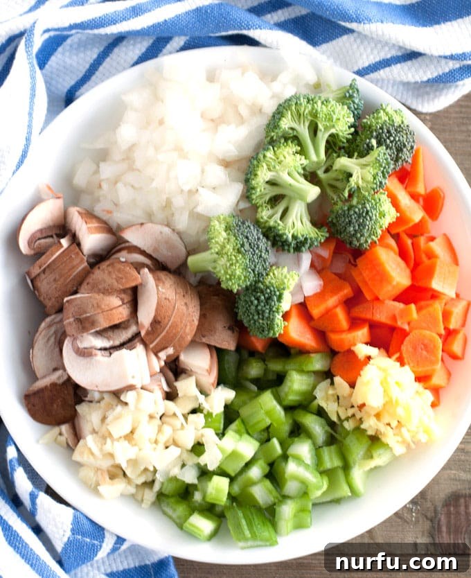 detox chicken soup Bowl with mushrooms, onions, broccoli, carrots, celery, garlic