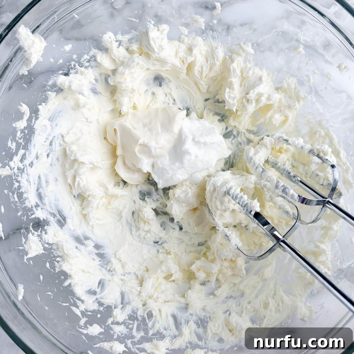 Chilled Crab Delight 4 Mixing bowl with whipped cream cheese, sour cream, and mayonnaise, showing the smooth, creamy base before adding other ingredients.