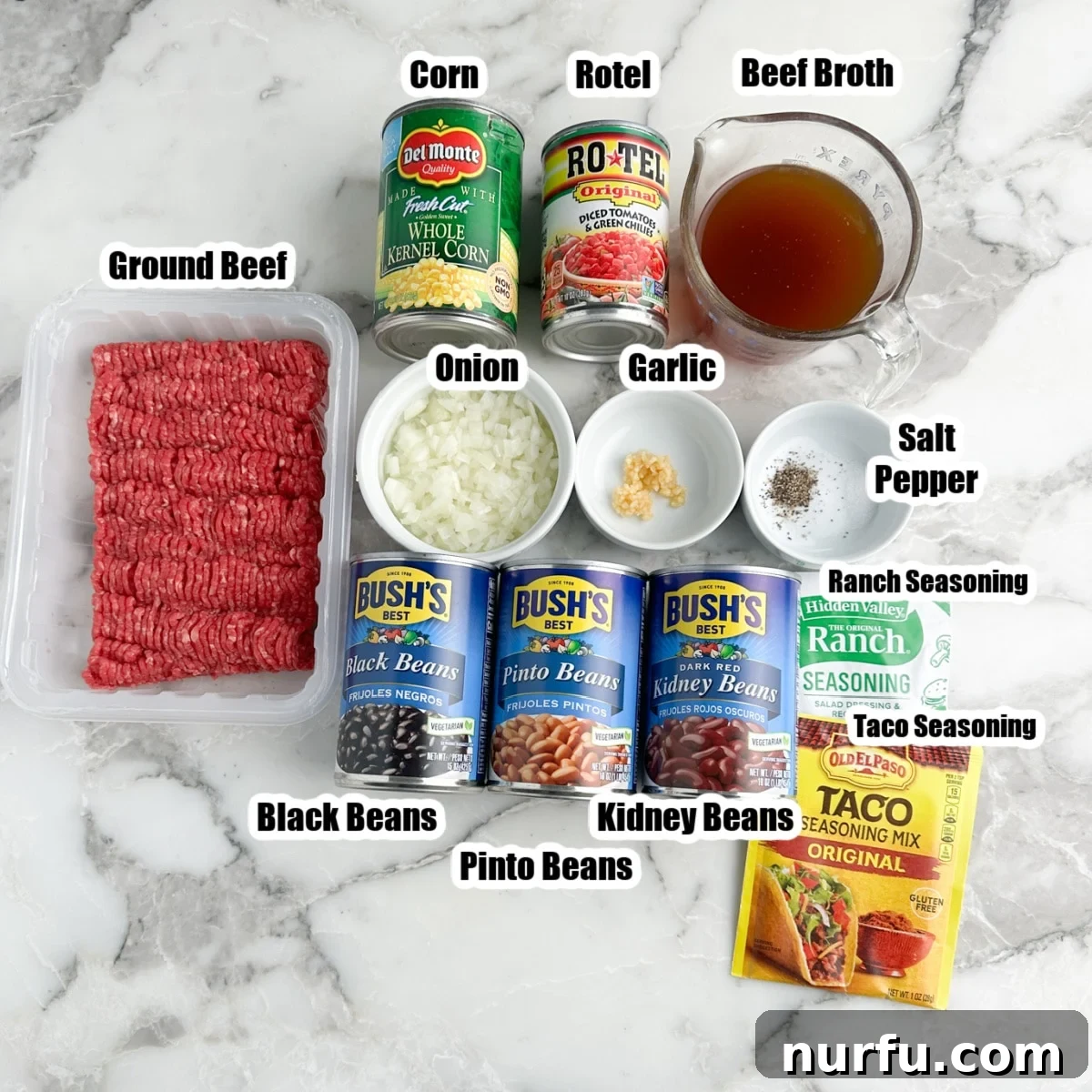 Southwestern Fiesta Soup 3 Various ingredients for Santa Fe soup laid out: ground beef, several cans of beans, corn, packets of seasonings, a can of Rotel, onion, garlic, and a carton of beef broth.