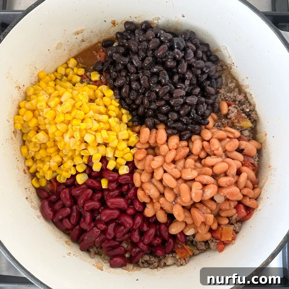 Southwestern Fiesta Soup 6 A pot of Santa Fe soup on the stovetop, with beans and corn added to the savory broth, ready for simmering to allow flavors to deepen.