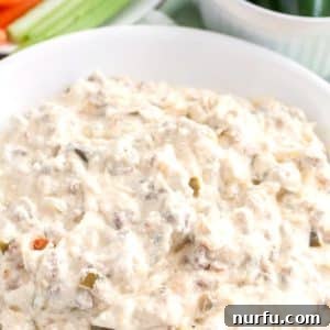 Creamy Slow Cooker Jalapeno Popper Dip 2 Creamy sausage dip served in a rustic bowl, garnished with fresh herbs, ready to enjoy.