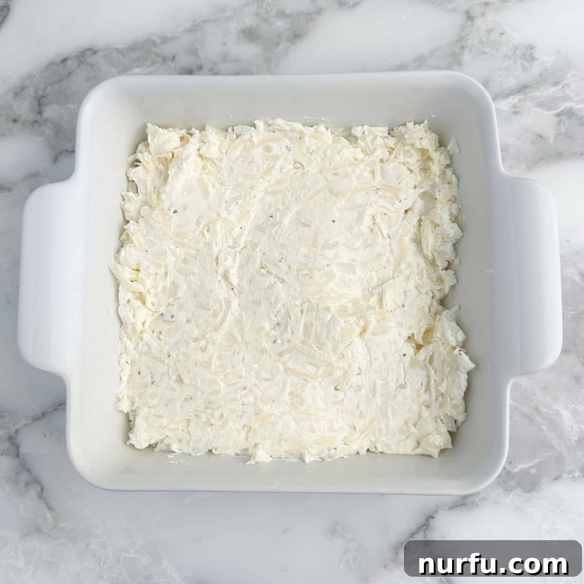 Irresistible Vidalia Onion Dip 7 A golden-brown, bubbly baking dish of Vidalia onion dip, freshly baked and ready to be served, emitting steam and inviting aroma.
