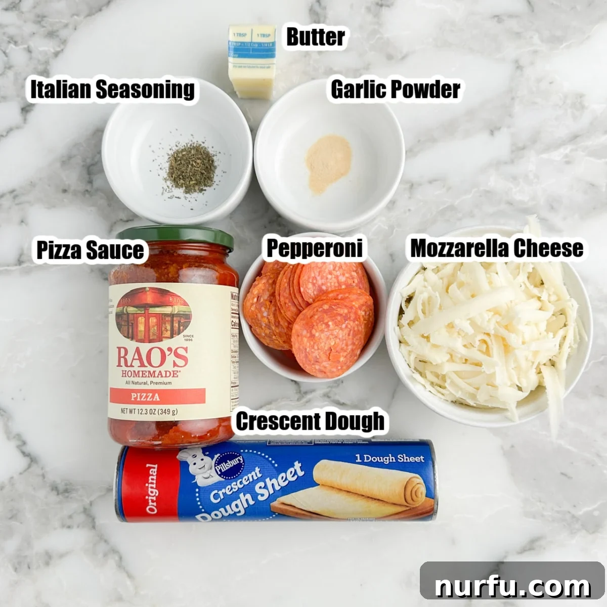 Pepperoni Pizza Swirls 3 Displayed ingredients for pepperoni pinwheels: crescent dough, pizza sauce, mozzarella cheese, pepperoni, and a selection of seasonings on a wooden board.