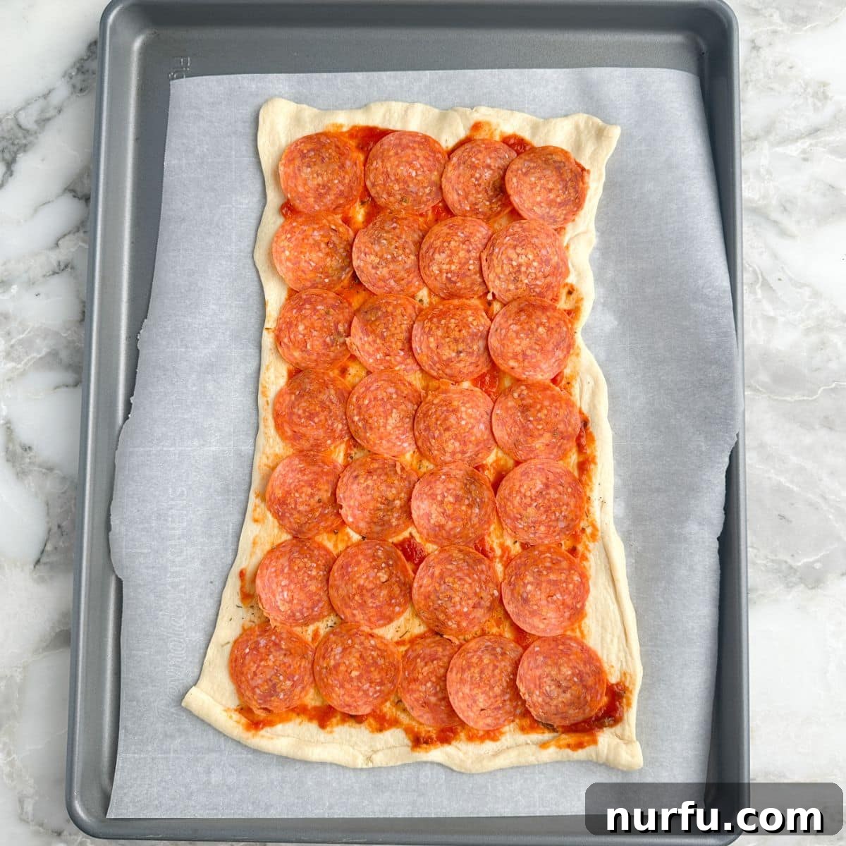 Pepperoni Pizza Swirls 6 Flattened crescent dough layered with delicious pepperoni slices, providing the savory base for the pinwheels.