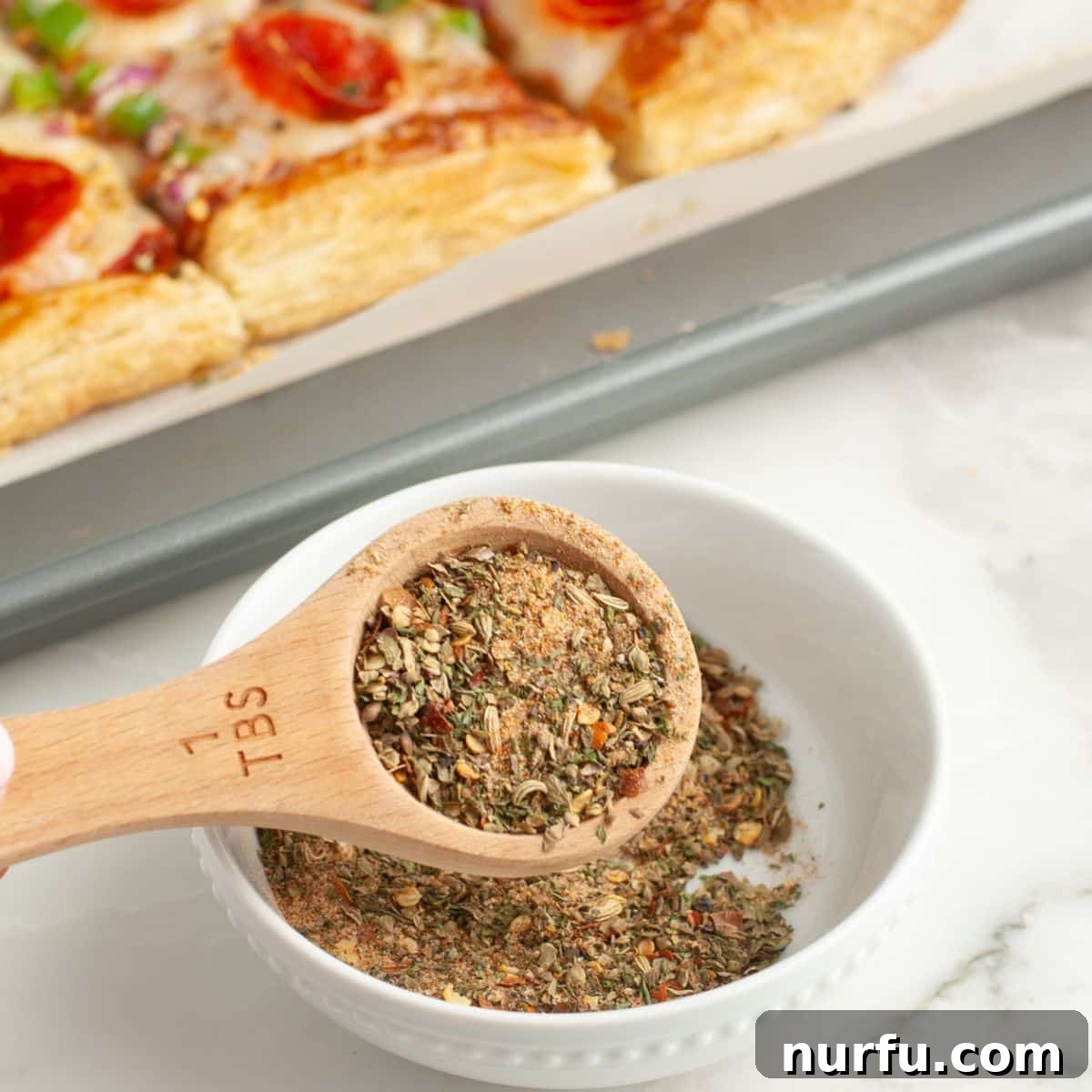 Perfect Homemade Pizza Seasoning Blend 2 Tablespoon with vibrant homemade pizza seasoning, ready to sprinkle on dishes.