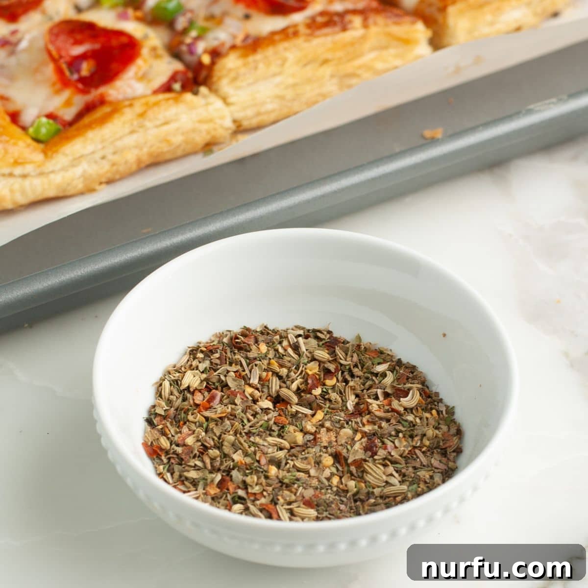 Perfect Homemade Pizza Seasoning Blend 4 Bowl filled with vibrant homemade pizza seasoning, ready for use.