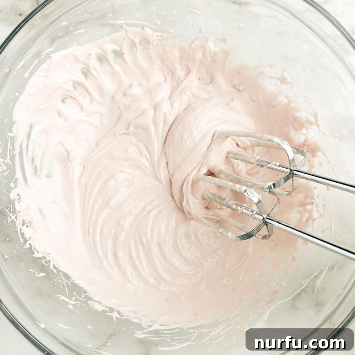 Strawberry Bliss Dip 5 Mixing the strawberry cream cheese and marshmallow fluff with an electric mixer.