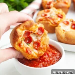Pizza cupcake dipping into marinara sauce.