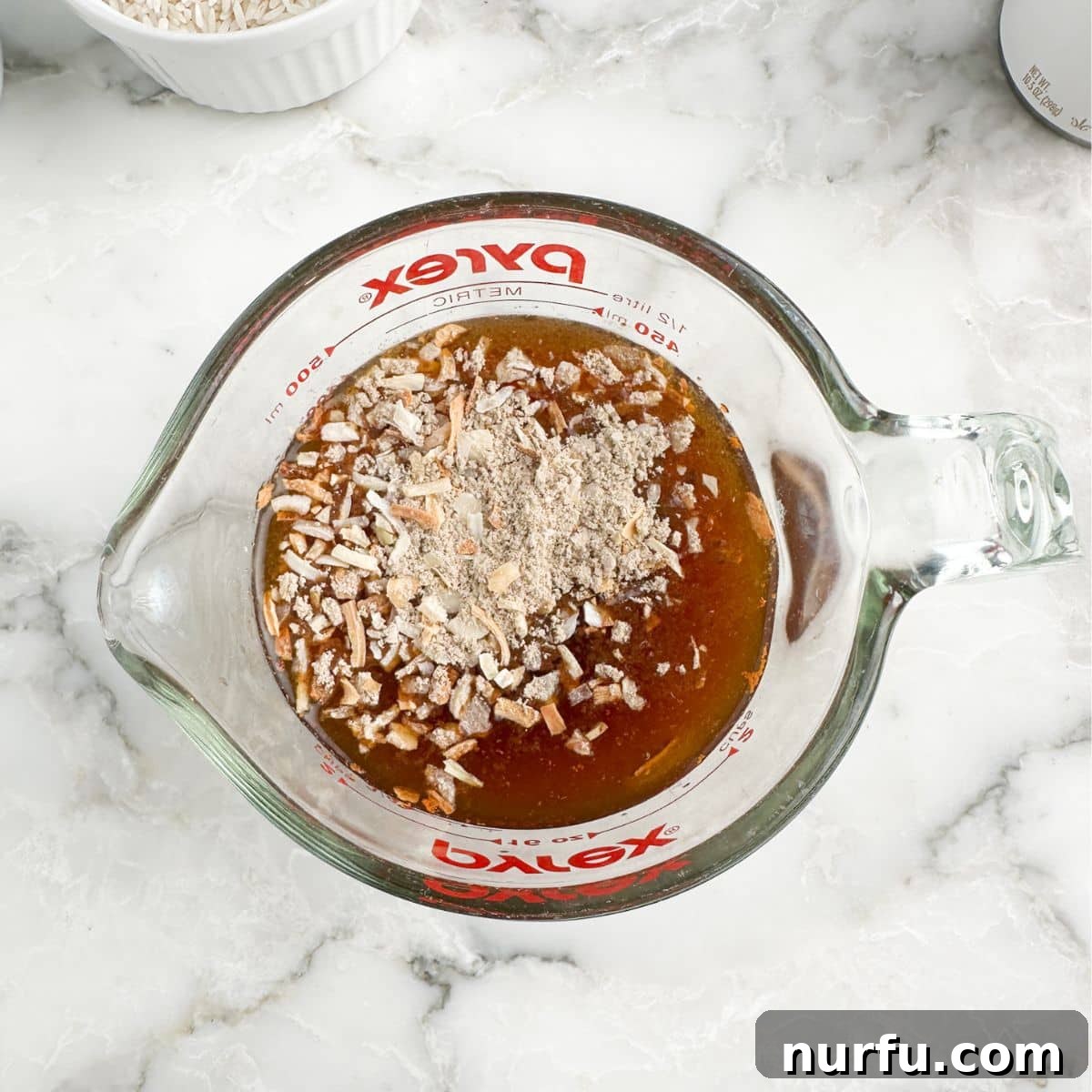 Caramelized Onion and Gruyere Rice 4 A clear measuring cup containing beef broth and a packet of Lipton onion soup mix, ready to be combined.