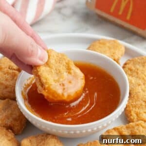 Perfect Homemade McDonalds Sweet and Sour Sauce 7 Bowl of sweet and sour sauce with chicken nugget.