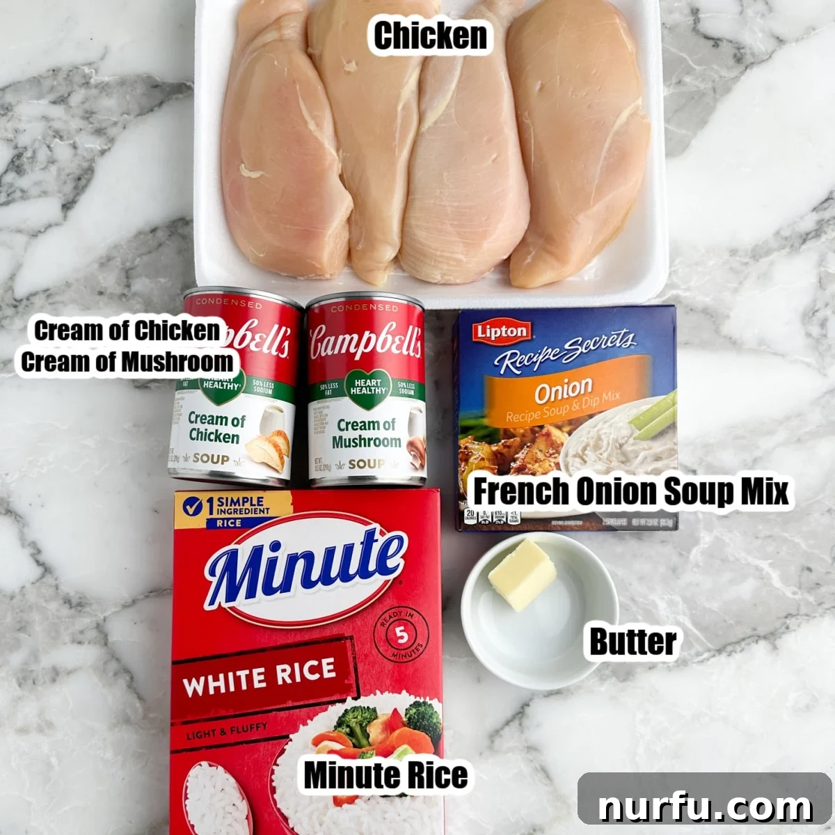 The Chicken That Time Forgot 3 Essential ingredients for Forgotten Chicken laid out: boneless chicken breasts, a box of Minute Rice, cans of cream of mushroom and cream of chicken soup, a packet of Lipton Onion Soup mix, and a stick of butter.