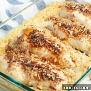 The Chicken That Time Forgot 9 A golden-brown baking dish filled with tender chicken pieces nestled atop creamy, savory rice, fresh from the oven and ready to serve.