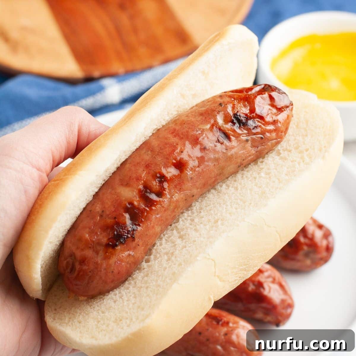 Perfectly Crispy Air Fryer Chicken Sausage 6 Chicken sausage served in a bun with colorful toppings, ready to eat.