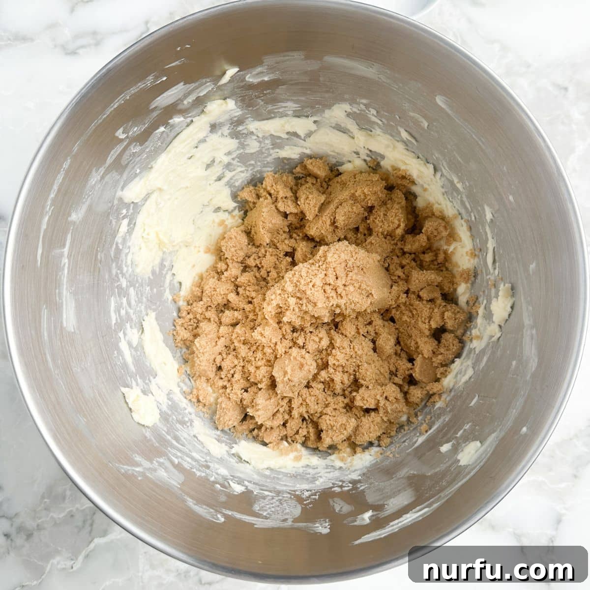 Gooey Brown Sugar Congo Bars 4 A mixing bowl containing softened butter and brown sugar, ready to be creamed together.
