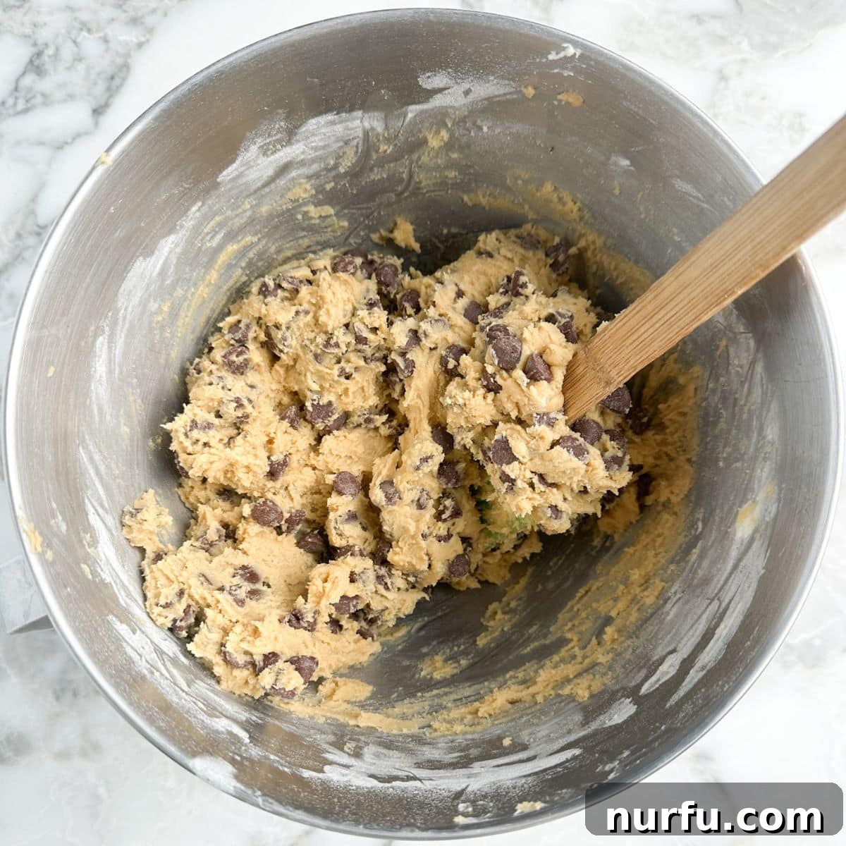 Gooey Brown Sugar Congo Bars 6 A close-up of thick chocolate chip cookie dough in a mixing bowl, ready for the baking pan.