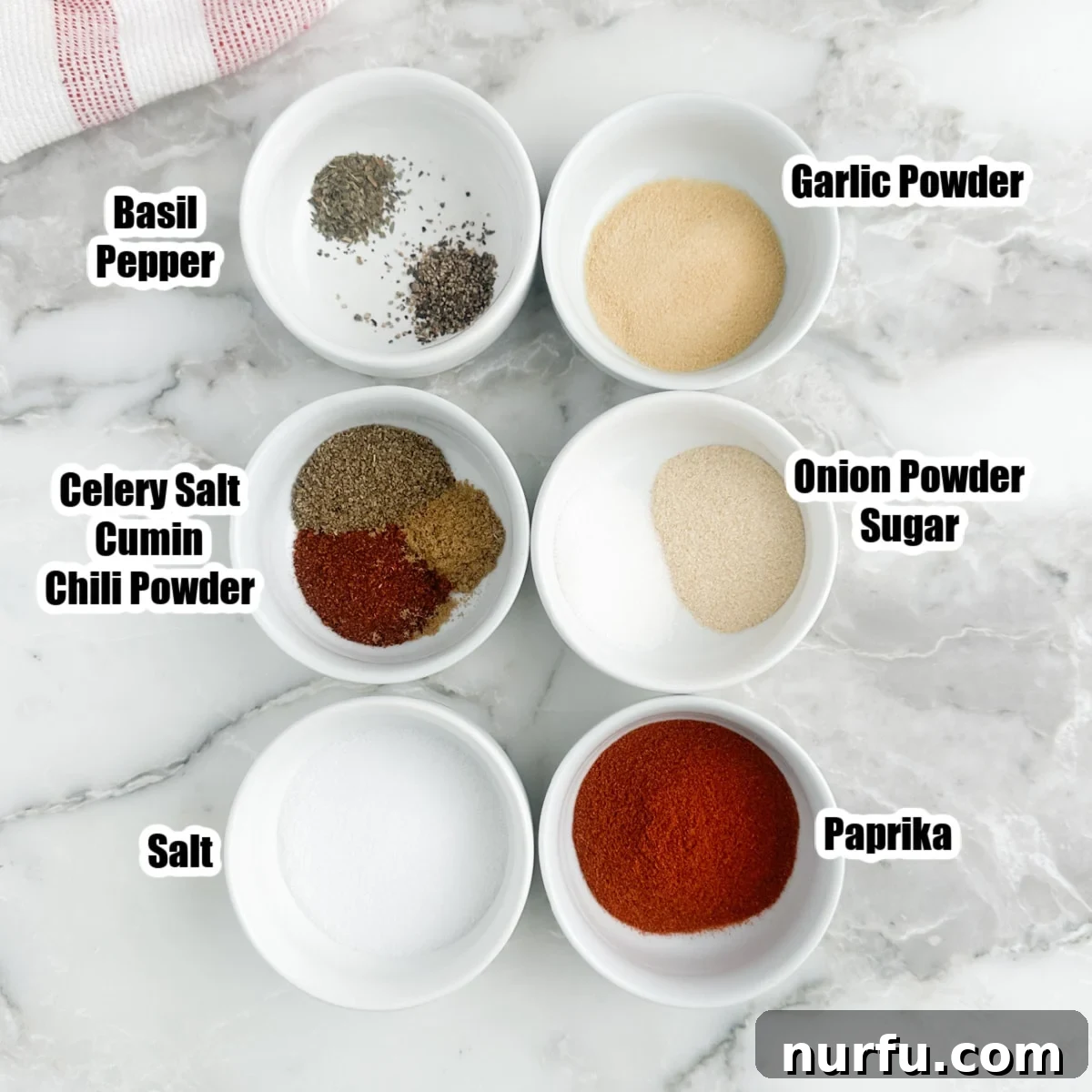 The Crimson Kitchen Blend 3 Several small bowls containing individual spices like paprika, garlic powder, salt, and chili powder, ready for mixing.