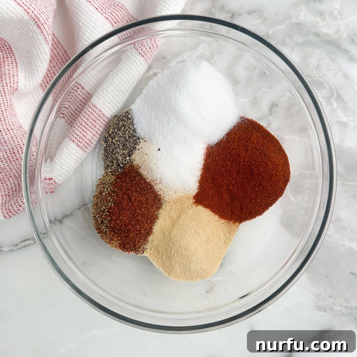 The Crimson Kitchen Blend 4 A large mixing bowl filled with the reddish-brown Red Robin seasoning blend.