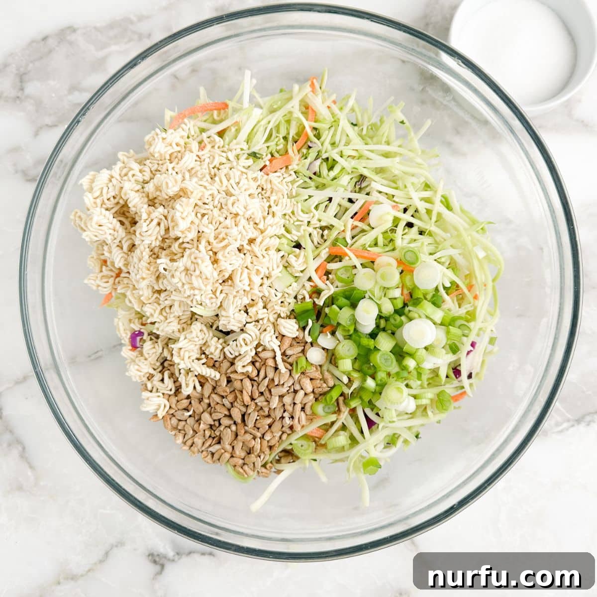 Crunchy Ramen Broccoli Salad 4 Bowl of broccoli slaw, sunflower kernels, green onions, and ramen noodles.