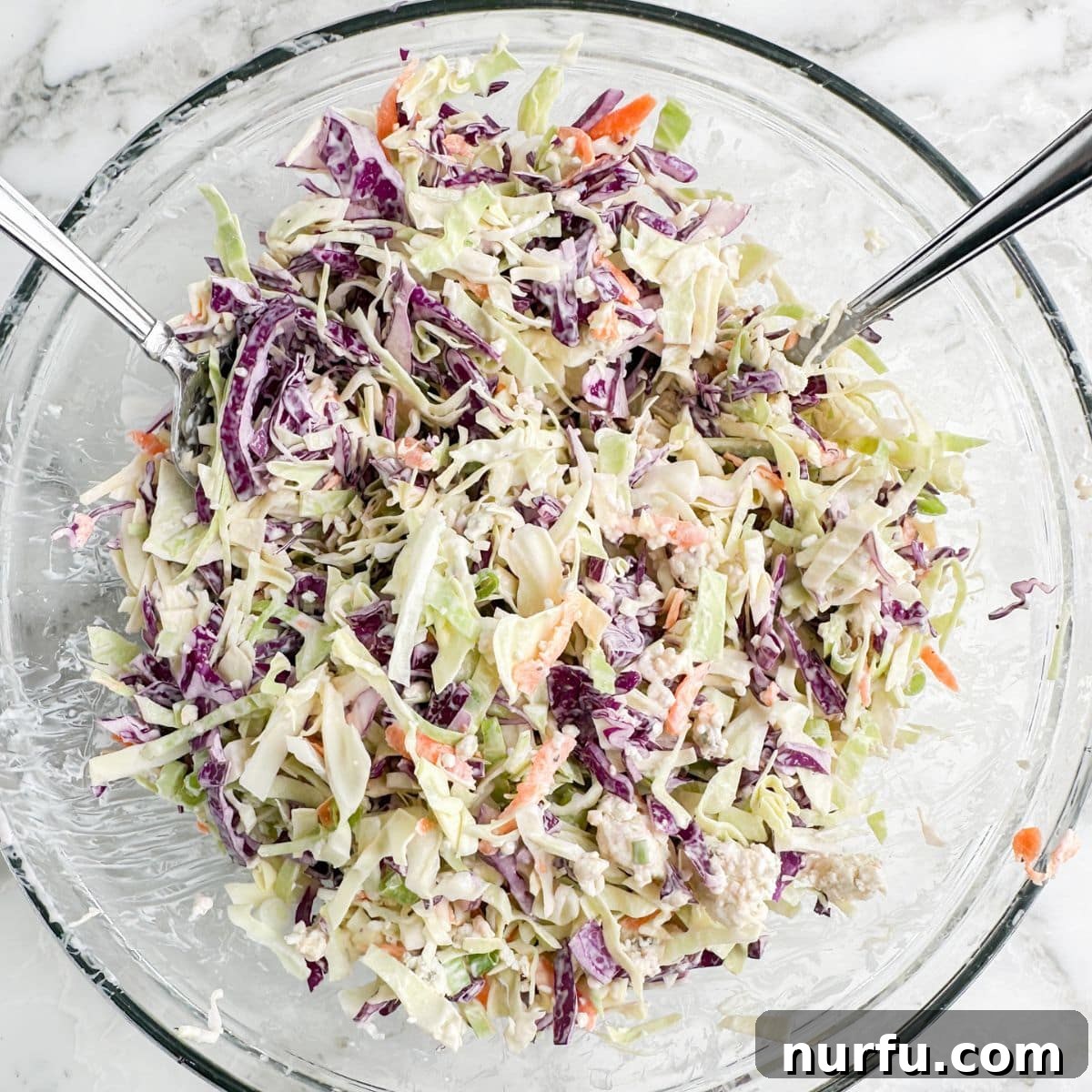 Bold Blue Coleslaw 8 A beautifully presented bowl of homemade blue cheese slaw, rich with creamy dressing and visible crumbles of blue cheese, garnished and ready for serving.